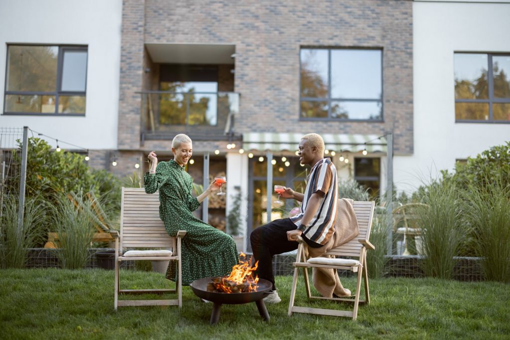 Couple drinking cocktails at home party in garden