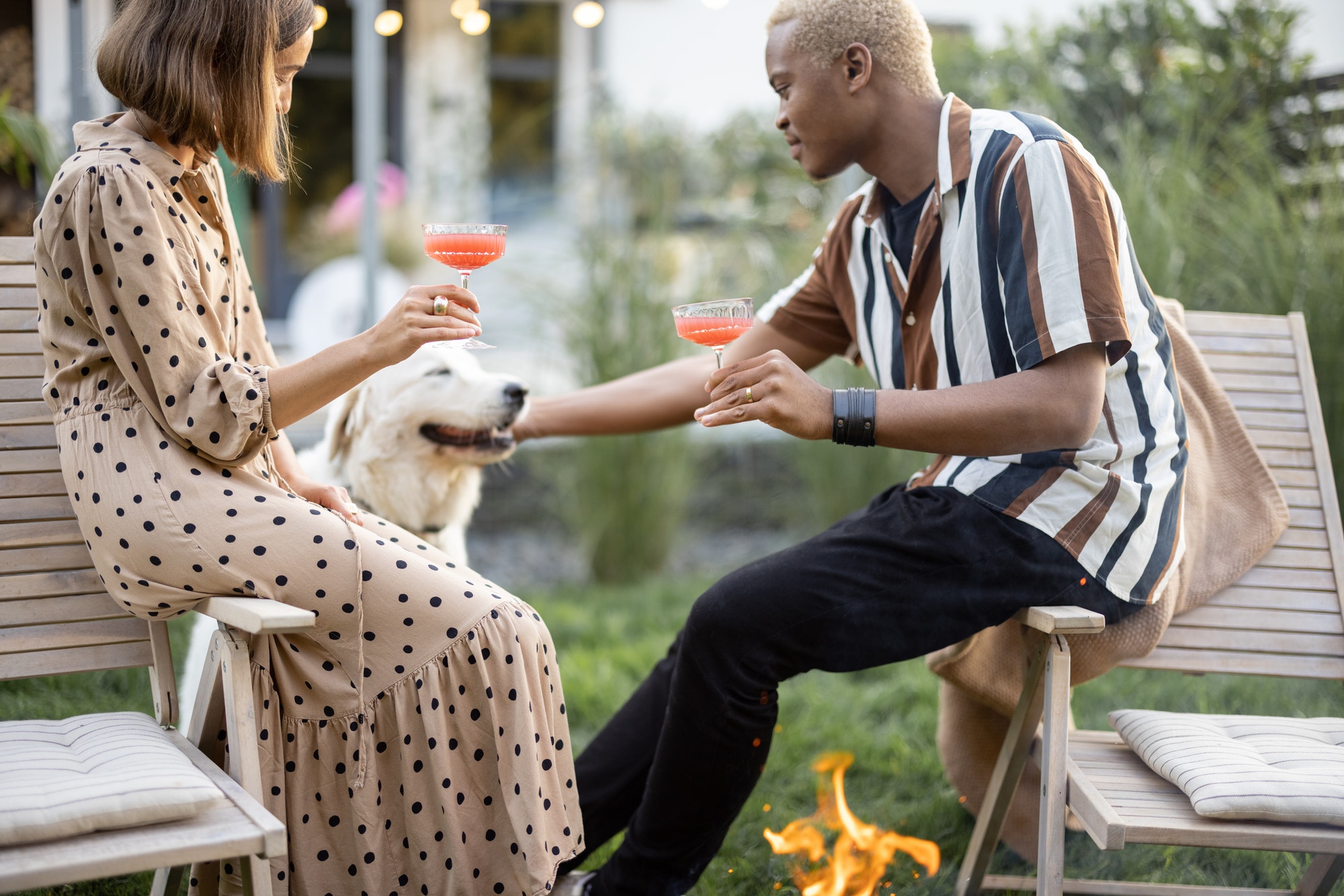Couple with dog at home party in garden