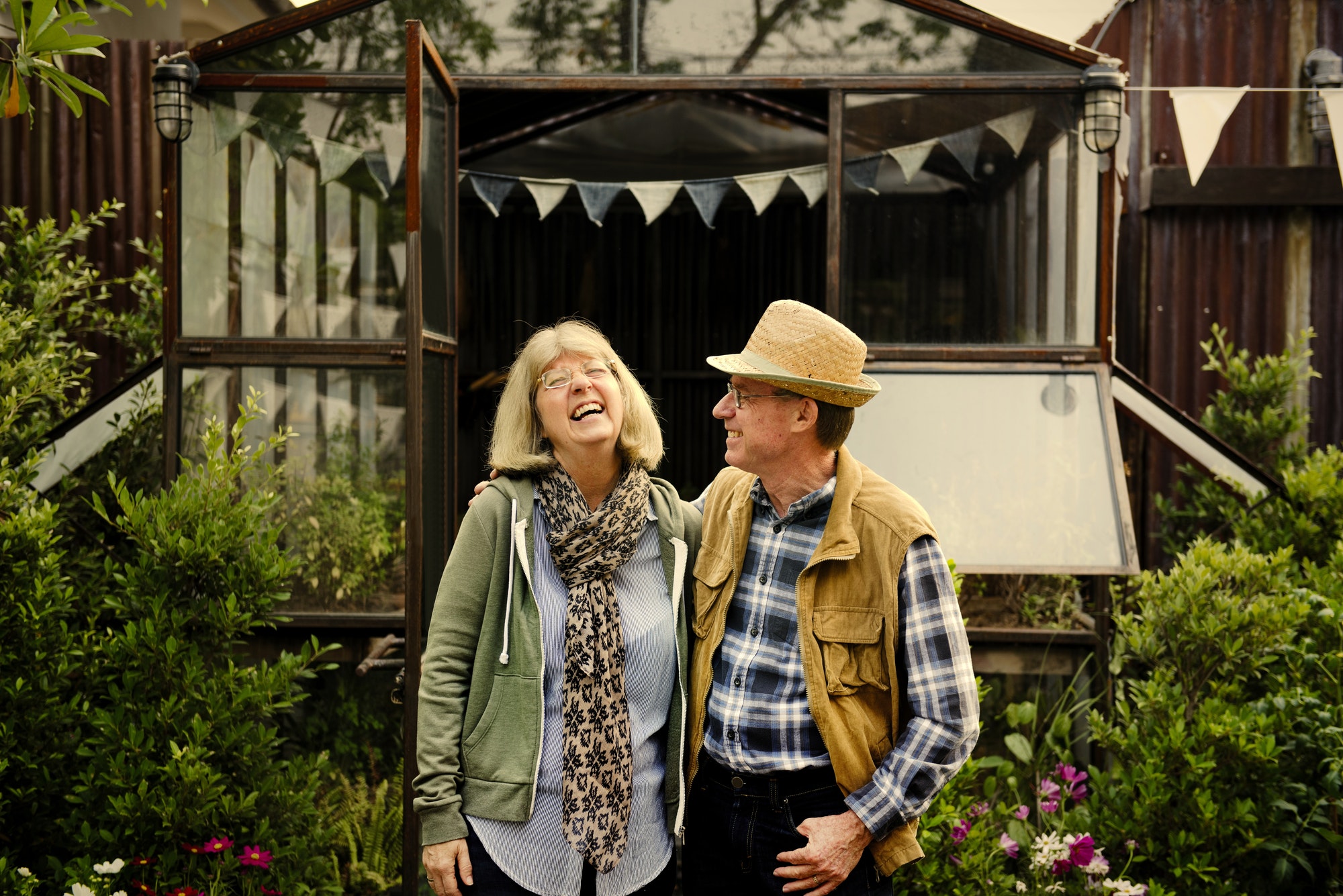 Senior couple planting vegetables at garden backyard